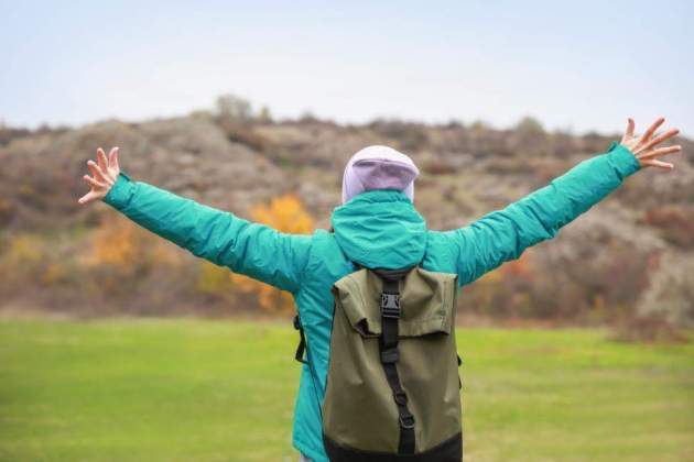 a person with arms outstretched outside