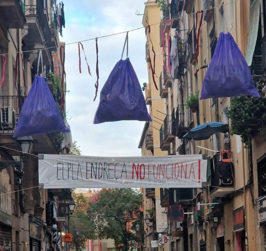 Vecinos del Raval denuncian la falta de limpieza en el barrio colgando bolsas de basura y una pancarta